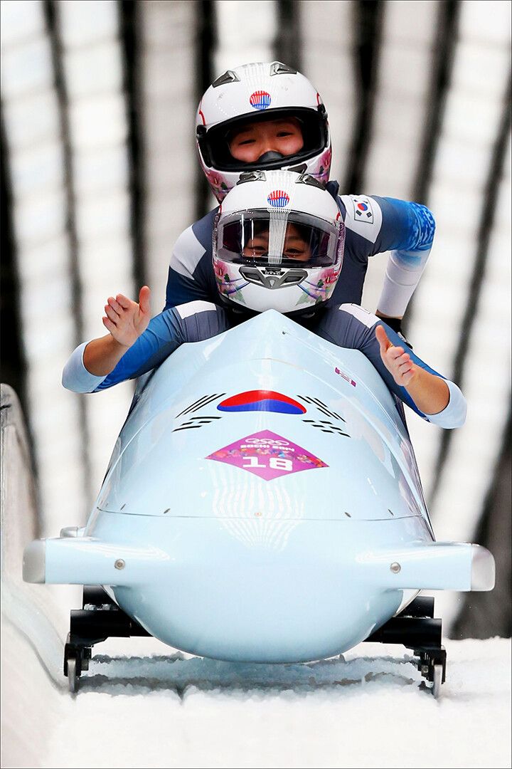 Bobsled Team In Front Of Bobsled Jigsaw Puzzle